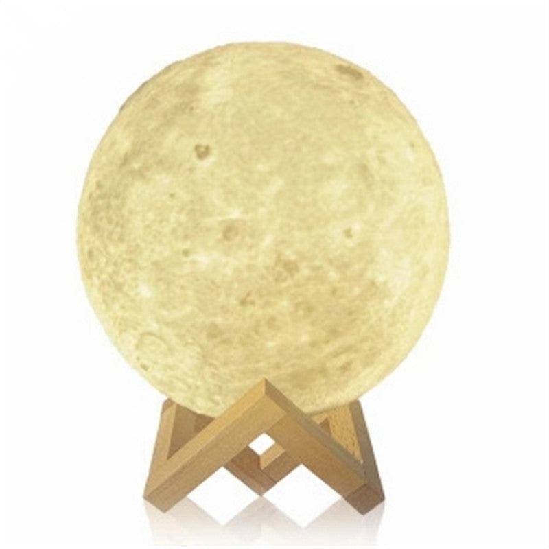 Mystical Moon Lamp casting a soft, warm glow, designed to resemble the surface of the moon with its detailed craters and mountains. The lamp is displayed on a wooden stand, highlighting its perfect round shape and providing a peaceful and calming ambiance to any room.