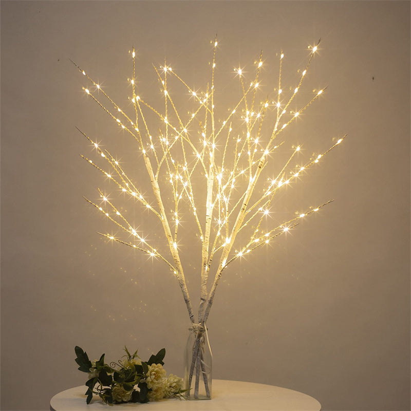Beautiful LED Birch Branch illuminated with warm white lights, adding a cozy and festive touch to any room. The branch is displayed against a neutral background, showcasing its natural birch texture and the soft glow of the LED lights.
