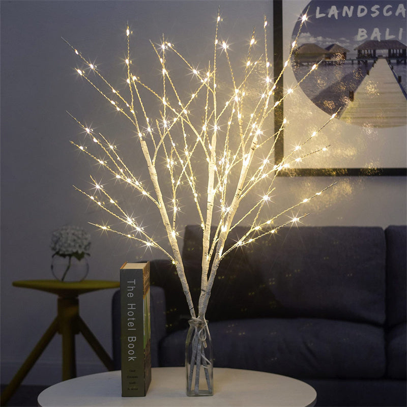 Beautiful LED Birch Branch illuminated with warm white lights, adding a cozy and festive touch to any room. The branch is displayed against a neutral background, showcasing its natural birch texture and the soft glow of the LED lights.