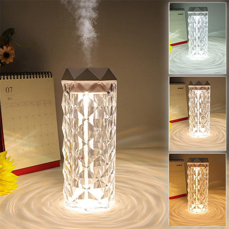 Elegant Air Humidifier Crystal Lamp emitting a soothing mist to improve air quality, paired with a warm, ambient light that glows through its crystal-like structure. The lamp is displayed on a wooden surface, highlighting its modern design and dual functionality as both a humidifier and a decorative lamp.