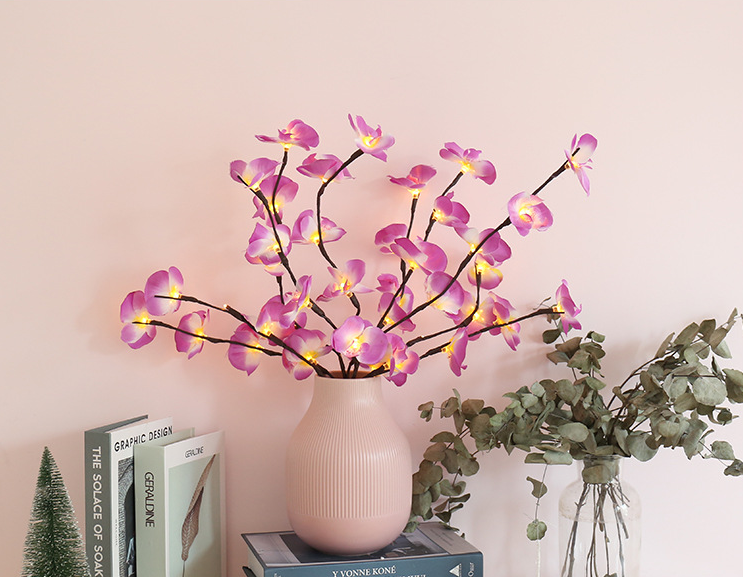 Branch Light adorned with delicate Phalaenopsis flowers.