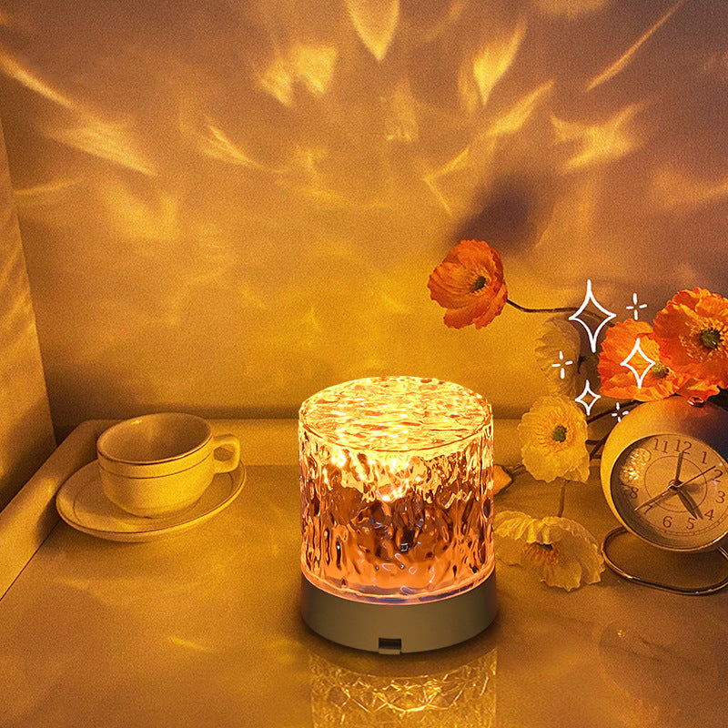 Contemporary Atmosphere Night Light emitting a soft and calming glow, perfect for setting a relaxed ambiance in any room. The light is designed with a sleek and minimalist aesthetic, and is displayed on a bedside table, highlighting its modern and versatile design.