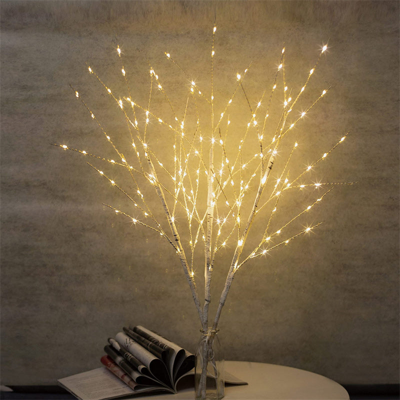 Beautiful LED Birch Branch illuminated with warm white lights, adding a cozy and festive touch to any room. The branch is displayed against a neutral background, showcasing its natural birch texture and the soft glow of the LED lights.