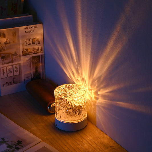 Contemporary Atmosphere Night Light emitting a soft and calming glow, perfect for setting a relaxed ambiance in any room. The light is designed with a sleek and minimalist aesthetic, and is displayed on a bedside table, highlighting its modern and versatile design.