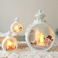 Candle lights illuminate festive retro window decorations