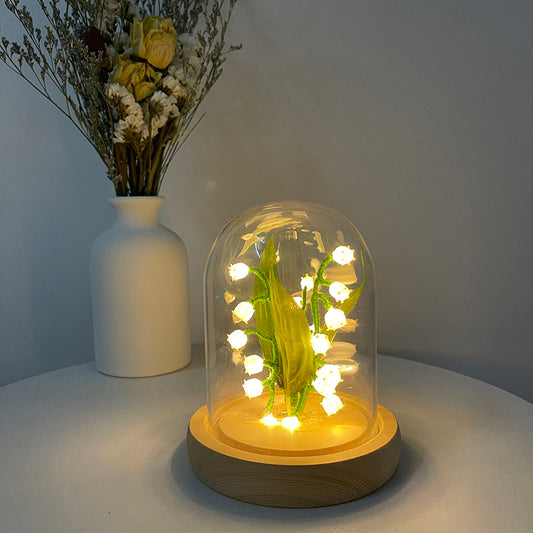 Glass Garden Lamp in a Garden Setting - An elegant glass lamp casting a soft, inviting glow in your garden, perfect for creating an enchanting outdoor atmosphere.